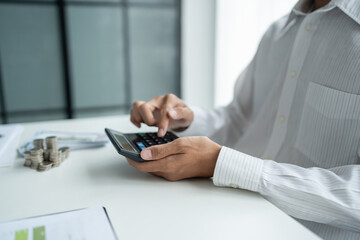 Businessman checking bills taxes bank account balance and calculating annual financial statements of company. Accounting Audit Concept