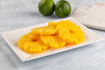 Sweet canned pineapple slices in syrope