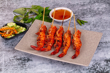 Grilled prawn skewer served sauce