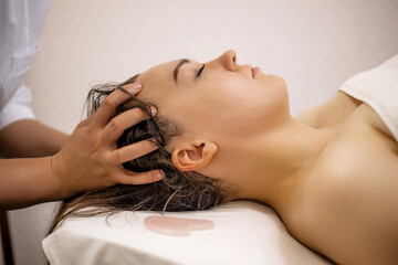 Japanese Head Massage Therapy for Relaxation and Stress Relief – Spa Treatment with Female Client Lying on Massage Table