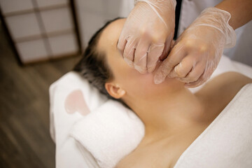 Buccal Massage Therapy in Beauty Spa – Woman Receiving Intraoral Facial Treatment by Professional with Gloves