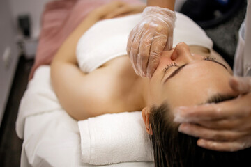Buccal Massage Therapy in Beauty Spa – Woman Receiving Intraoral Facial Treatment by Professional with Gloves