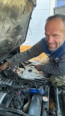 male mechanic repairing car engine