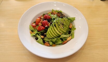 Fresh Healthy Salad with Avocado, Berries, Nuts and Greens