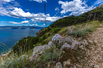 Hiking trail leading from the beach in Baska to the Bag mountain, city panorama seen from above,