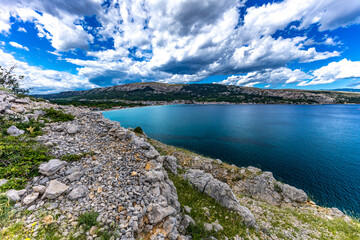 Hiking trail leading from the beach in Baska to the Bag mountain, city panorama seen from above,