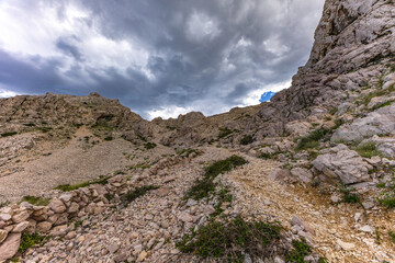 Climbing the Bag peak on the island of KRK, a view of the panorama of the city of Baska, sharp rocks,
