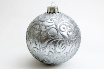 Silver christmas ornament with swirl design on white background