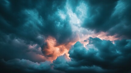 Dramatic Cloudy Sky, A dramatic sky filled with thick, turbulent clouds in shades of dark teal and blue, with bursts of orange and pink light breaking through the center, suggesting either sunrise/sun