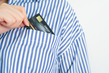 shopping from home concept from beauty woman hand pull credit card from her shirt pocket for shopping order discount sale item online with white isolated background