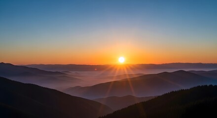 Fototapeta premium Mountain Range at Colorful Sunrise with Fog Rolling Through Valleys