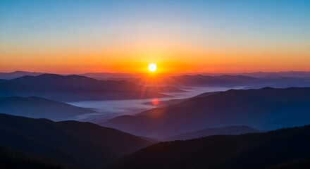 Orange Sunrise Over Rolling Blue Mountains with Mist, Scenic Landscape