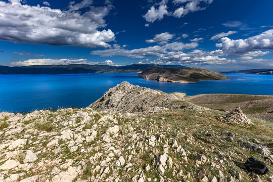 Climbing the Bag peak on the island of KRK, a view of the panorama of the city of Baska, sharp rocks,