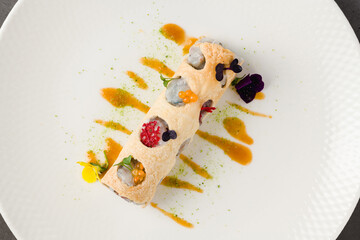 Rolled crispy crepe filled with seafood, herbs, and microgreens