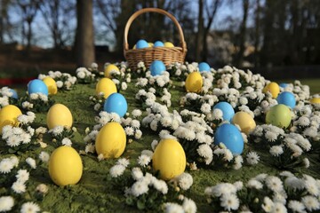 A photo of yellow and blue Easter eggs