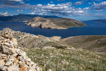 Climbing the Bag peak on the island of KRK, a view of the panorama of the city of Baska, sharp rocks,
