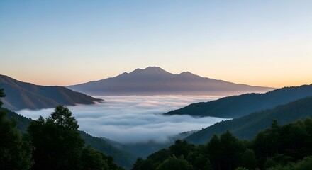 Scenic Mountain Peak Emerging Above Sea of Clouds at Dawn