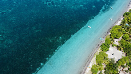 Scenic aerial view of idyllic ocean with crystal clear turquoise water and white sandy beach on Atauro Island, Timor-Leste, Southeast Asia