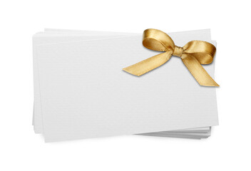 Blank gift card with golden bow on white background, above view. Mockup for design