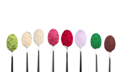 Different superfood powders in spoons on white background, collage. Top view