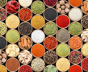 Set of different aromatic spices in bowls on black background, flat lay