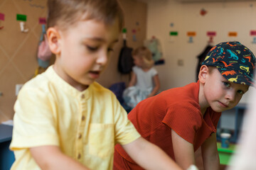 Preschool daycare interior showing kids’ changing area and a room for board games and tabletop activities. Organized early learning environment