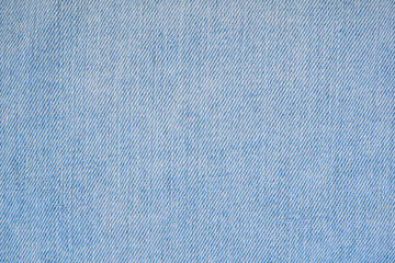 Jeans textile close up. Detail of light blue denim pants.	
