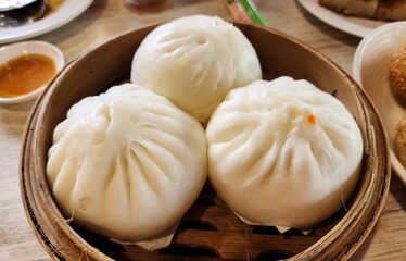 Soft and Steamed Buns in Traditional Bamboo Steamer Basket