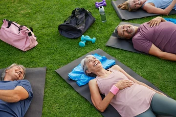Selbstklebende Fototapeten Entspannung Seniors relaxing after yoga at park  © Rido