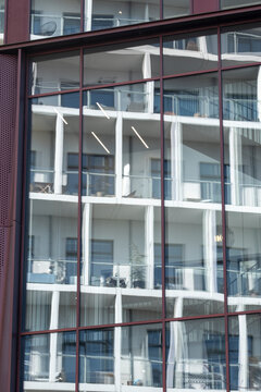 Residential building with metal frame and balconies forming visual grid, architecture texture for construction, housing or clean design visuals