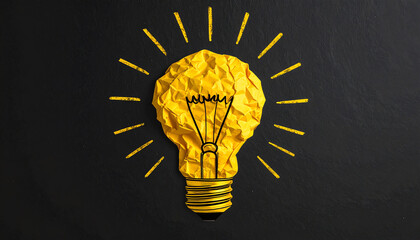 A creative depiction of a light bulb made from crumpled yellow paper, radiating bright lines on a dark background, symbolizing ideas and inspiration