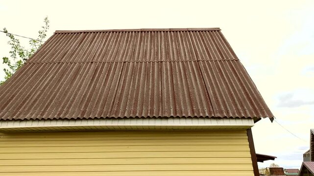 Facade of a new single-story rural house clad with siding, wall and roof