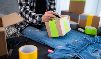 Girl Preparing Cardboard Box For Shipping