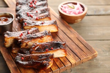 Delicious spare ribs on wooden table, closeup