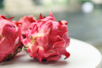 Delicious pitaya fruits on white table outdoors, closeup. Space for text