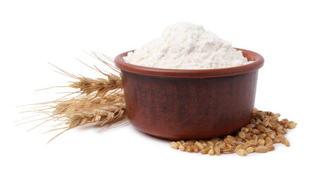 Wheat flour in bowl, grains and spikes on white background