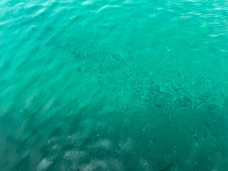 Clear lake water reveals sandy bottom