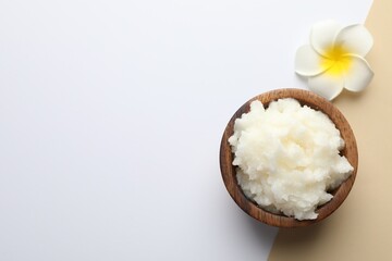 Shea butter and plumeria flower on color background, top view. Space for text