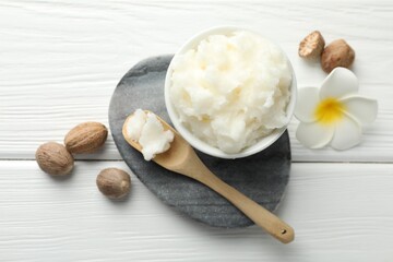 Natural shea butter on white wooden table, flat lay