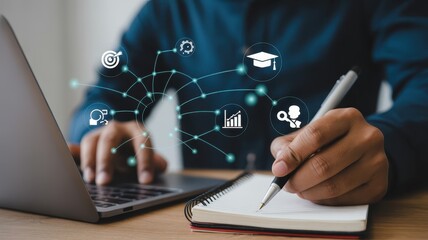 Person using a laptop and taking notes, conceptual image of professional development.