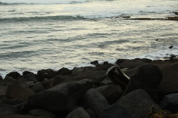 View of beautiful wavy sea and rocky beach