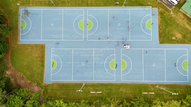 Aerial View of Sports Courts with Active Players