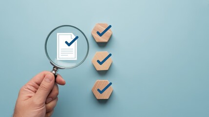 Magnifying glass focusing on a document with check mark.