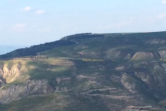 Mountain Landscape with Winding Road and Green Hills
