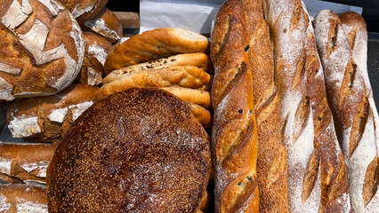 A variety of breads sold at a market stall.