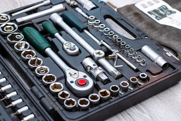Fototapeta premium A toolbox with sockets and wrenches on a wooden table
