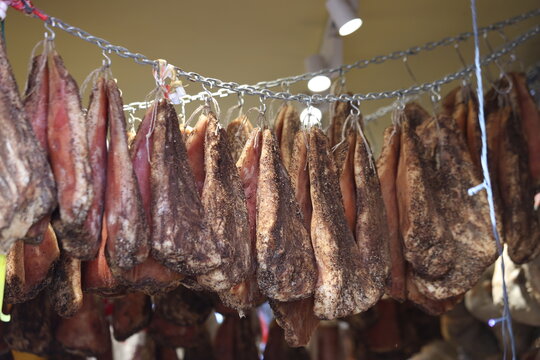 Cured meats (Salumi) hanging in a Charcuterie shop