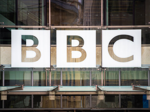 London, United Kingdom - May 26, 2025: Close-up of the BBC logo displayed prominently on a modern glass building facade, 