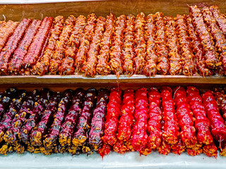 There are many different types of churchkhela on the counter.