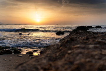 Golden sunrise illuminating the mediterranean coast of alicante, spain
